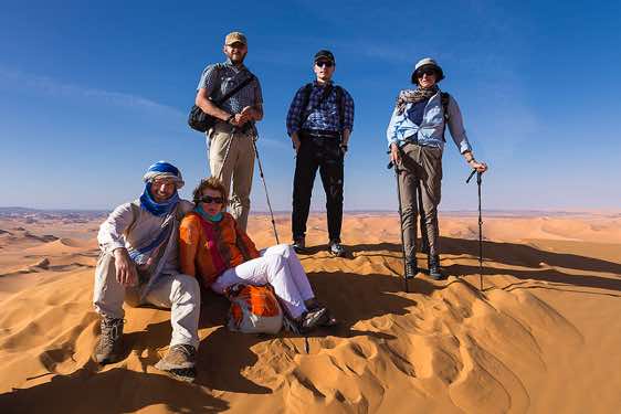 Our group made it on top of a tall sand dune, southern Oued In Tehak, Tadrart region, Tassili n ́Ajjer National Park, Sahara, North Africa