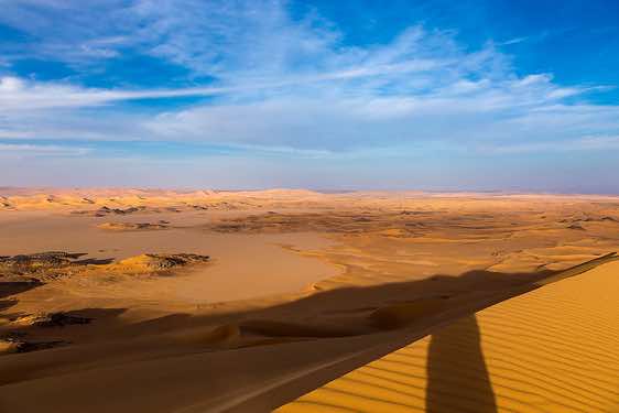 Claypan or playa and sand dunes of Oued In Djerane, Tadrart region, Tassili n ́Ajjer National Park, Sahara, North Africa