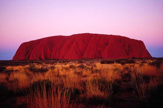 Ayers Rock (Uluru) produces an incredible light show at sunset, Kata Tjuta National Park, Northern Territory