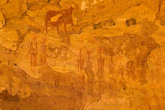 Prehistoric rock art panel of human figures with large decorated hairstyles and domesticated animals, Terkei West, Ennedi Mountains, northeastern Chad