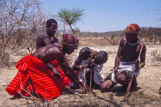 Samburu warriors making a fire, Samburu village