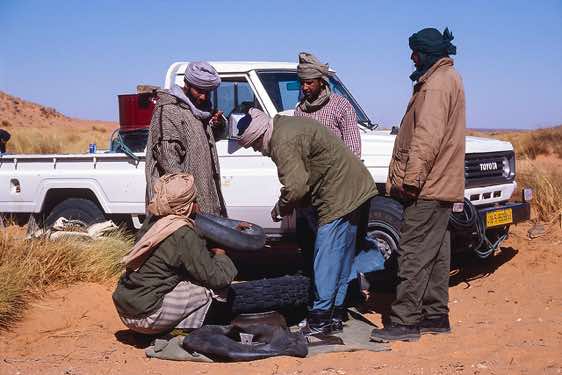 Repairing a flat tyre, Jabal Akakus