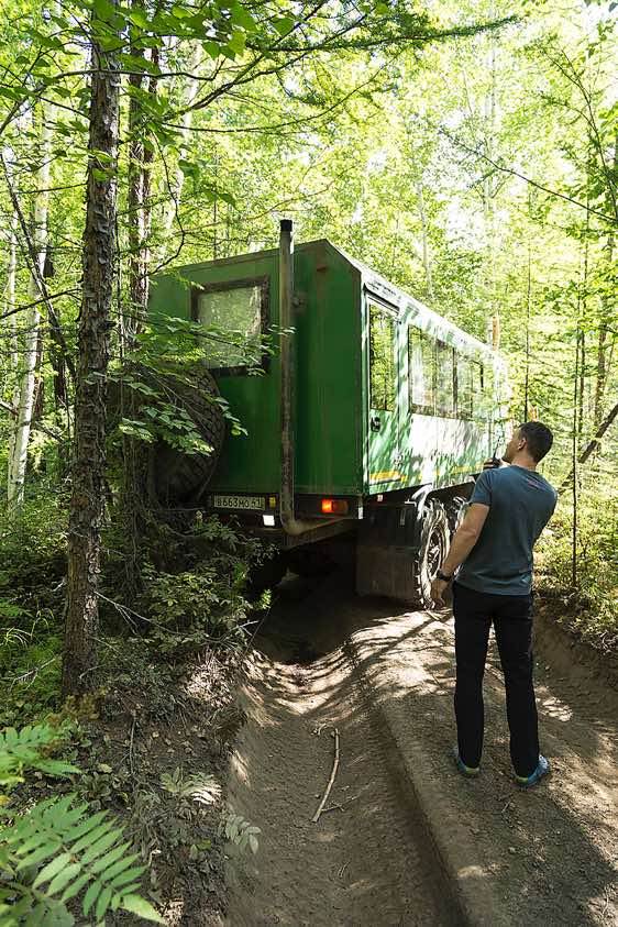 Guide Igor watches as the Kamaz truck manoeuvres its way along the forest road