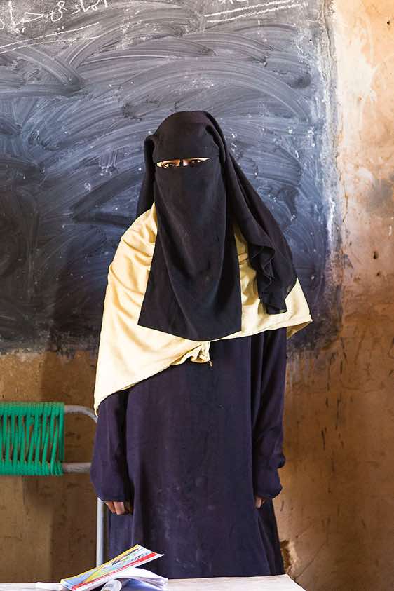 Veiled local teacher at school, Bayuda Desert, Northern Sudan