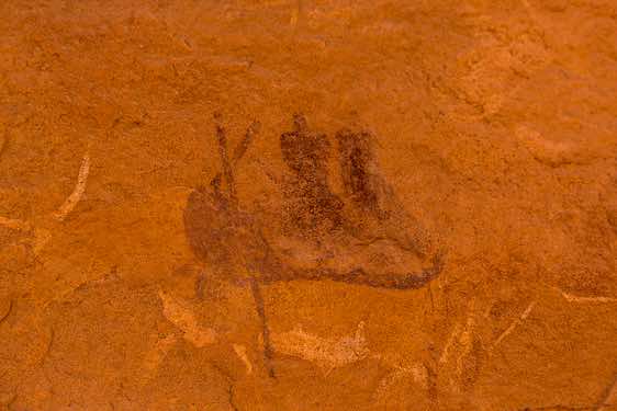 Rock painting of two people sitting in a canoe, Neolithic rock art, Tadrart region, Tassili n ́Ajjer National Park, Sahara, North Africa