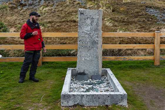Sir Ernest Shackleton's grave at Grytviken cemetery. Josh gives a toast to the legend and raises his glass filled with whisky.