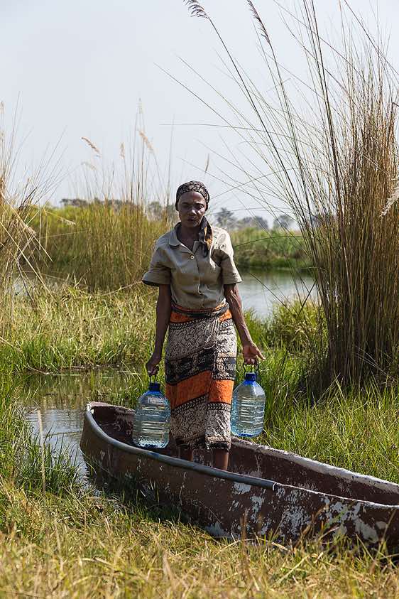 Local woman with water containers, Okavango Delta