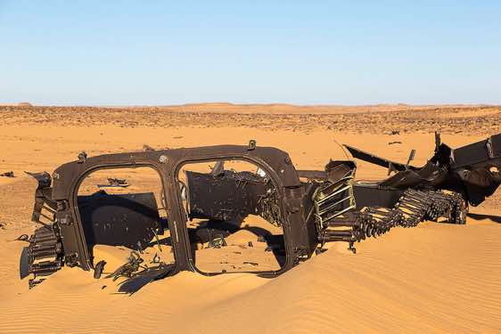 The remnants of a Libyan armoured personnel carrier in the desert sand