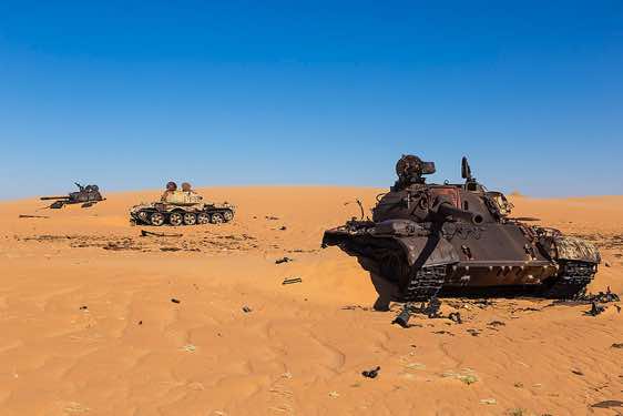 The remnants of Libyan tanks in the desert sand
