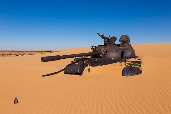 A Libyan tank is slowly buried by the desert sand