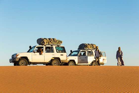 Off-road vehicles near desert campsite