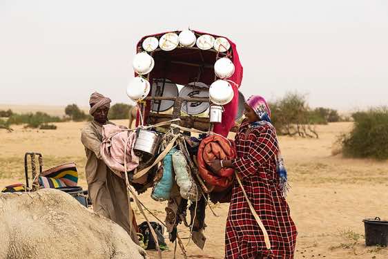 Nomadic family loading their camel at their campsite near Kouba Olanga, Borkou region