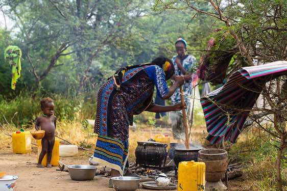 Wodaabe (Bororo) woman preparing food at a small camp or wuro that was set up for the Gerewol festival