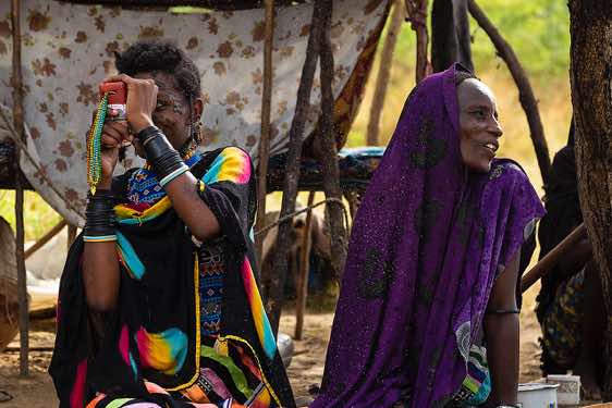 Wodaabe (Bororo) woman with mobile phone at campsite, Gerewol festival