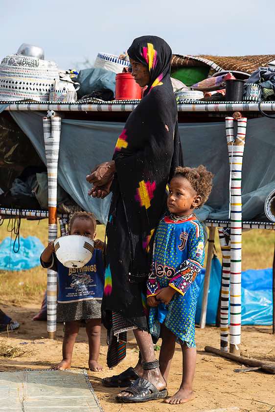 Wodaabe (Bororo) woman with her kids at the family's campsite, Gerewol festival