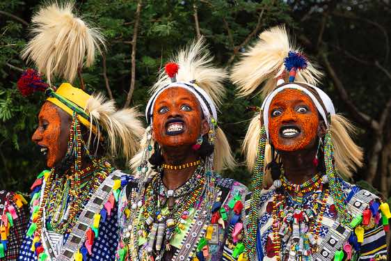 Wodaabe (Bororo) men attempt to attract the attention of the women by showing off their teeth and the whites of their eyes at the Gerewol festival