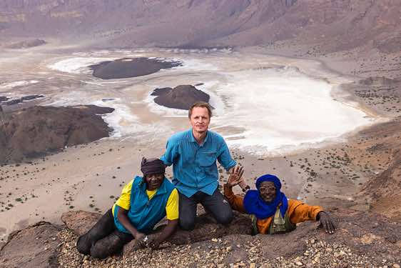 The photographer poses at the crater rim of Trou au Natron with our local guide Omar (right) and our cook Hassan, Tibesti region