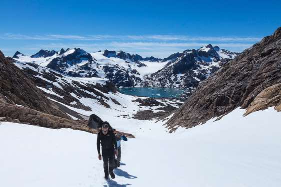 Group ascending an icefield near Sangmileq Fjord, Ammassalik Island