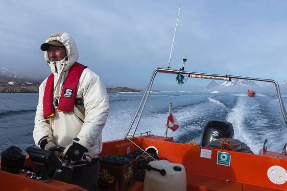 Inuit steering a boat, Ammassalik Fjord