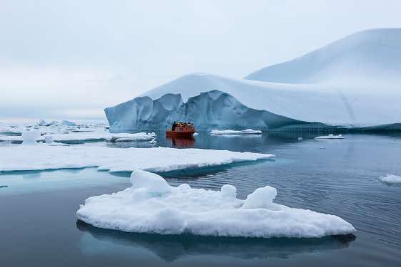 Boat approaching iceberg, Ammassalik Island