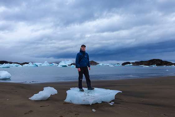 The photographer standing on a block of ice, campsite near Sermilik Research Station, Sermilik Fjord, Ammassalik Island