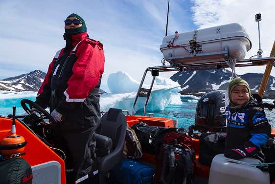 Inuit steering the boat from Kulusuk Island to Tasiilaq, Ammassalik Fjord
