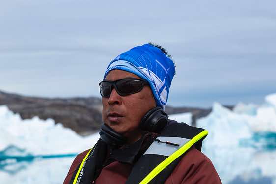 Inuit steering the boat, Sermilik Fjord