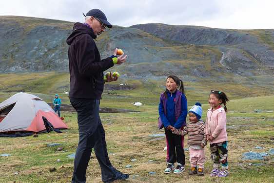 Uli juggling for nomad kids at campsite, Tavan Bogd National Park, Altai Mountains, Western Mongolia