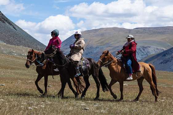 Mongolian kitchen crew - Bota, Uash and Duzka - on horses, Tavan Bogd National Park, Altai Mountains, Western Mongolia