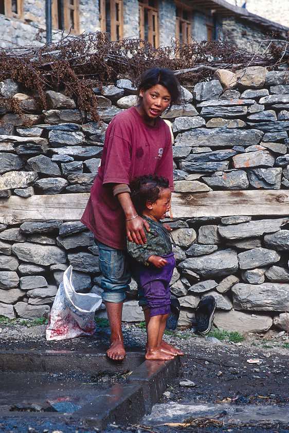 A mother is washing her reluctant child, Pisang, Manang Valley