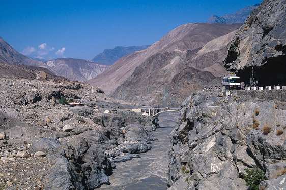 The Karakoram Highway crosses to the west bank of the Indus river over the Raikot Bridge