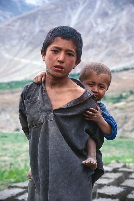 Boy enjoying a piggyback-ride, Askole, Karakoram Mountains