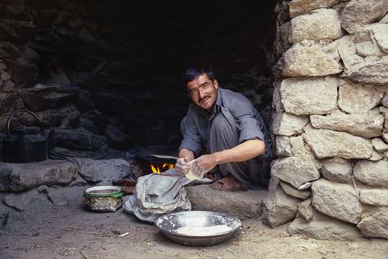 A porter making chapati, Camp Paiju, Karakoram Mountains