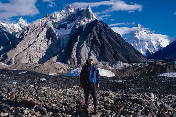 The photographer at Concordia, with Marble Peak and K2 in the background, Karakoram Mountains