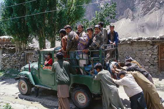 Porters wave goodbye at their departure, Hushe, Karakoram Mountains