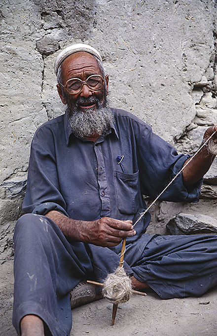 Man spinning wool Karakoram