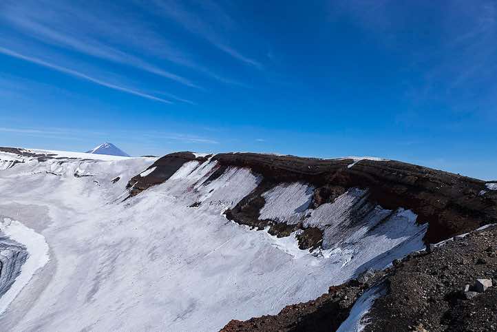 A huge (3 km diameter) circular collapse caldera is located on the summit of Plosky Tolbachik, 3085m