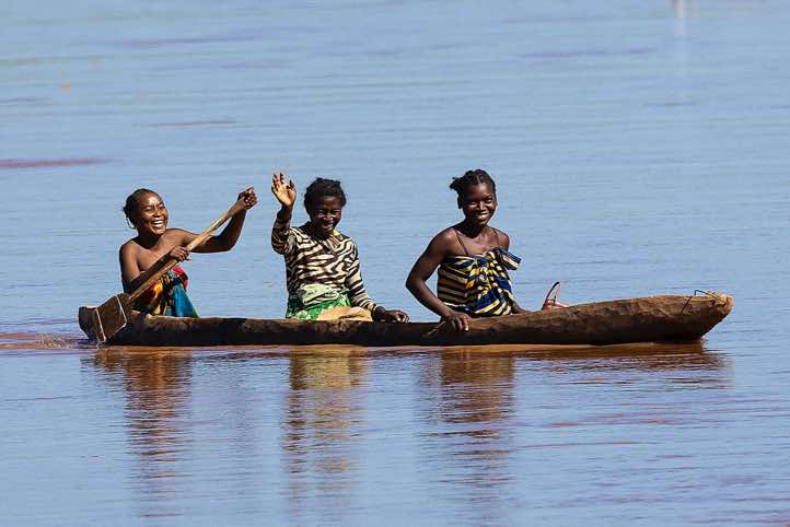 Women in a wooden canoe on the Tsiribihina River, Western Madagascar