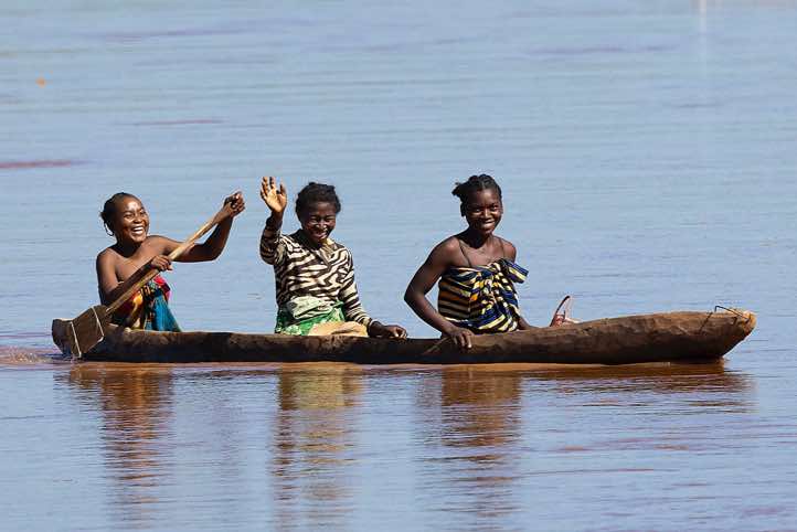 Women in a wooden canoe on the Tsiribihina River, Western Madagascar