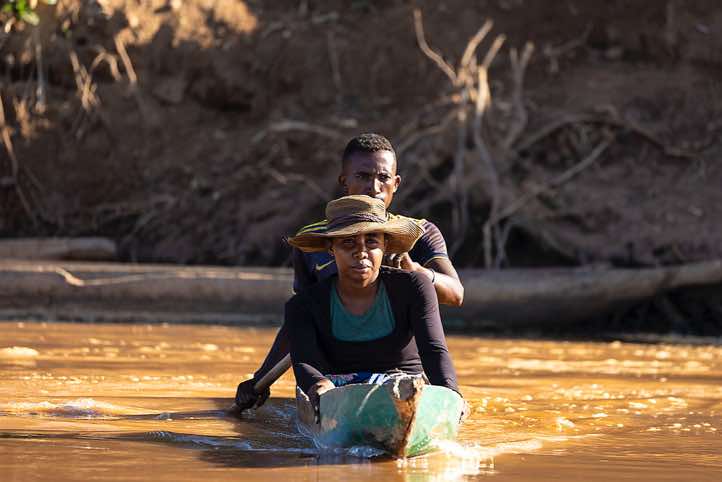 Couple in a wooden canoe on the Tsiribihina River, Western Madagascar