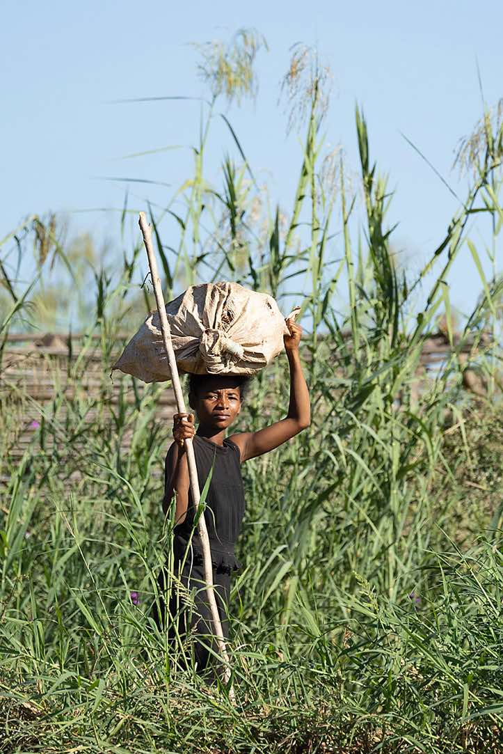 Woman with a heavy load on her head, Tsiribihina River, Western Madagascar