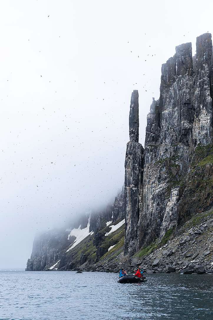 Zodiac cruising at the bird cliffs of Alkefjellet, Hinlopen Strait