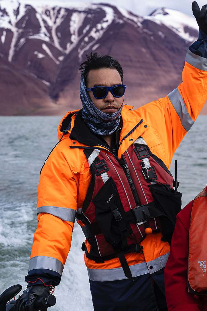 Plancius crew member steering the zodiac, Bockfjorden